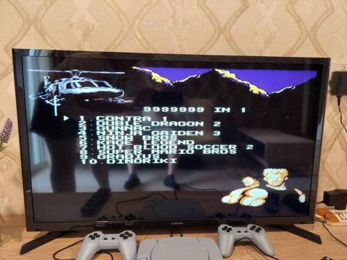 a television with two video game controllers in front of it at IPOH CITY CENTRE Majestic Homestay Pool View 3 mins Walking to Famous Food Places & 15mins to Old Town Ipoh by Happy Homestay in Ipoh