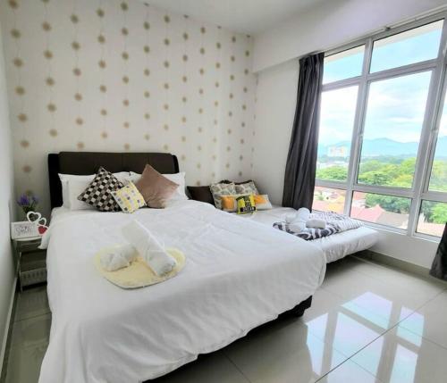 a bedroom with two beds and a large window at IPOH CITY CENTRE Majestic Homestay Pool View 3 mins Walking to Famous Food Places by Happy Homestay in Ipoh