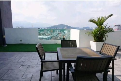 a table and chairs on a balcony with a view at IPOH CITY CENTRE Majestic Homestay Pool View 3 mins Walking to Famous Food Places & 15mins to Old Town Ipoh by Happy Homestay in Ipoh