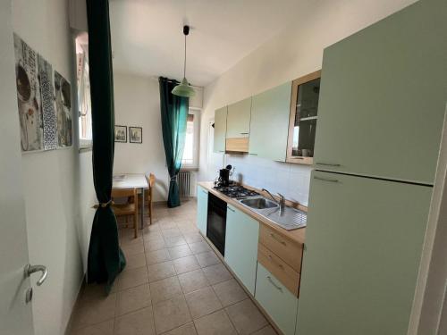 a kitchen with a white refrigerator and a sink at Haus and Beach in Brenzone sul Garda