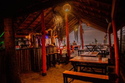 a restaurant with tables and chairs on the beach at Brother's Beach Home in Galle