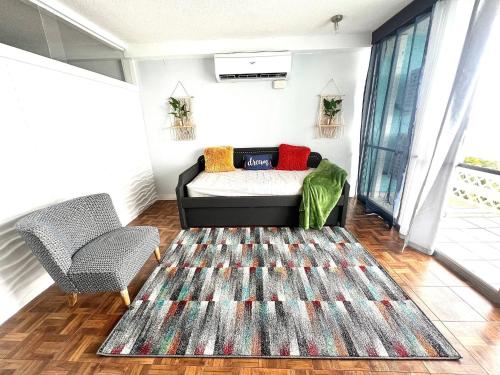 a living room with a bed and a rug at Sea View 1br sleeps 4 in Fajardo