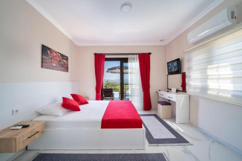 a bedroom with a large white bed with red pillows at Explore Cragos House , Land of Lights, Lycia in Kadıköy