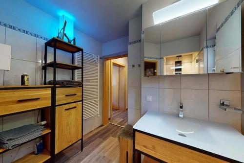 a large bathroom with a sink and a counter at Ski in Ski Out neu und gehoben in Saalbach-Hinterglemm