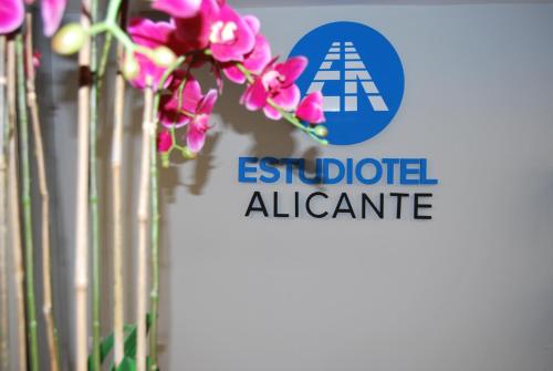 a sign for the esidot alpine centre with pink flowers at Estudiotel Alicante in Alicante