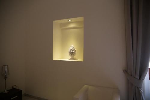 a small vase sitting on a shelf in a room at Apollo Suites in Lecce