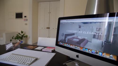 a computer monitor and a laptop on a desk at Apollo Suites in Lecce