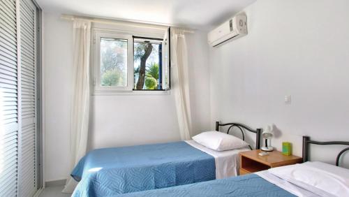Ένα ή περισσότερα κρεβάτια σε δωμάτιο στο Blue Bay Apartment