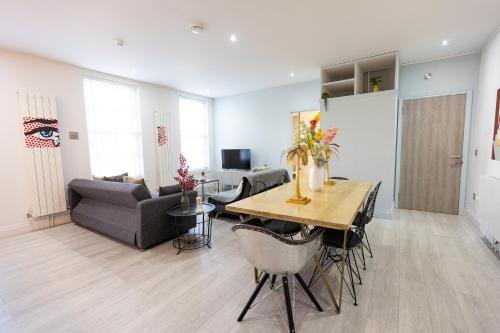 a living room with a table and a couch at Nadler House Flat 1 & 2 in Norwich