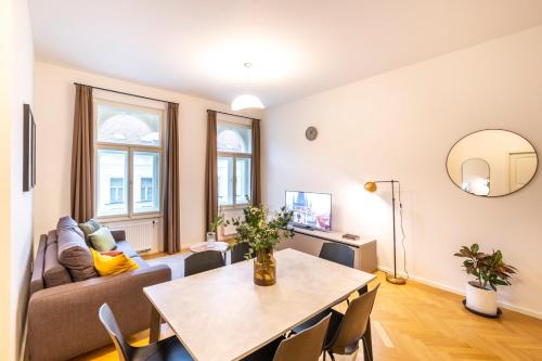a living room with a table and a couch at Petrin Tower Residence in Prague