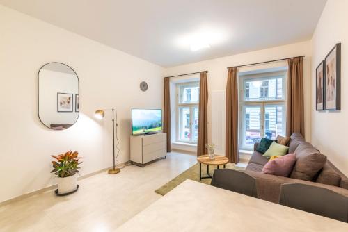 a living room with a couch and a table at Petrin Tower Residence in Prague
