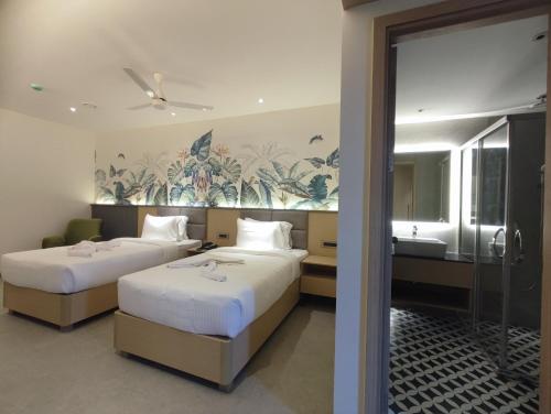 Katil atau katil-katil dalam bilik di Signature Hotels