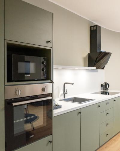 a kitchen with a sink and a microwave at KOOS Hotel&Apartments - City Aparthotel in Munich