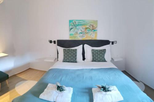 a bedroom with a blue bed with two towels at Villa Lemon Garden - Apartment in Dubrovnik in Mlini