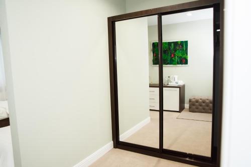 a mirror with a black frame in a room at Hotel VinoGrad in Haysyn