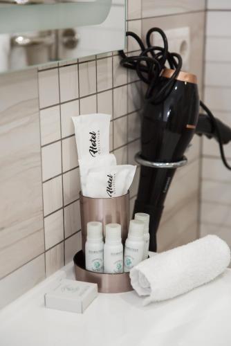 a counter top with a container with toiletries on it at Hotel VinoGrad in Haysyn