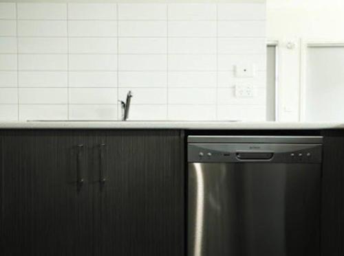 a kitchen with a sink and a stainless steel dishwasher at Little Bluebird Kuranjang 31min drive to MEL airport in Melton