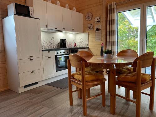 a kitchen with a table and chairs in a room at Emsflair in Kluse