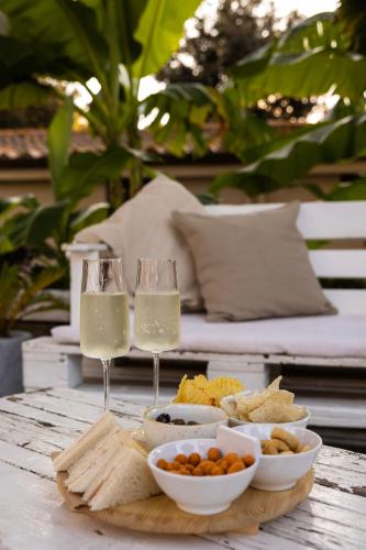 two glasses of wine and food on a table at La Pineta Dei Liberti in Lido dei Pini