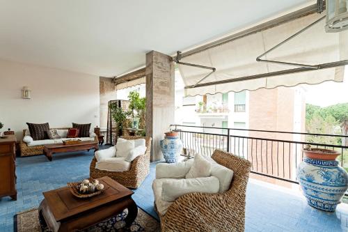 a living room with a balcony with chairs and a table at Casa Azul in Sorrento