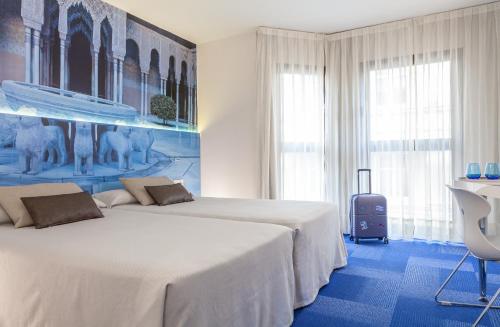 Ένα ή περισσότερα κρεβάτια σε δωμάτιο στο Hotel Maciá Granada Five Senses Rooms & Suites