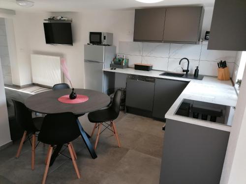 - une petite cuisine avec une petite table et des chaises dans l'établissement Apartma Pr Urarj, à Kobarid