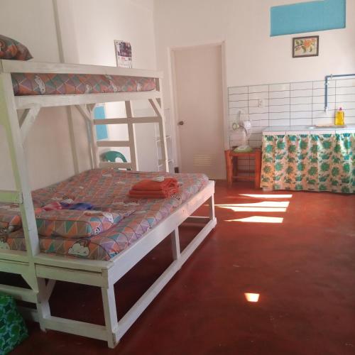 a bedroom with a bunk bed in a room at Lucky777 Homestay in Mambajao