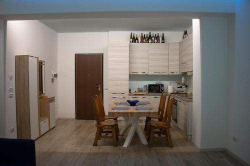 a kitchen with a table and chairs in a room at House Of Music in Gardone Riviera