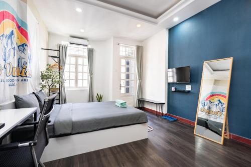 a bedroom with a large bed and a desk at Friday Saigon Centre Homestay in Ho Chi Minh City