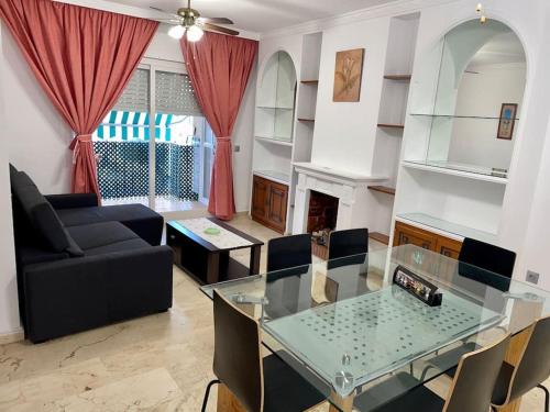a living room with a glass table and a couch at Apartamento en Marbella in Marbella