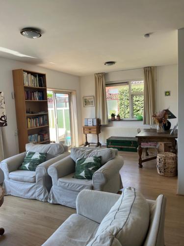 ein Wohnzimmer mit 2 Sofas und einem Tisch in der Unterkunft huize Louwra in Egmond-Binnen