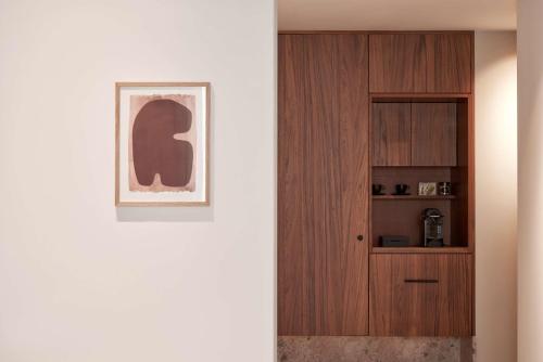 a hallway with a wooden door and a cabinet at The Social Athens Hotel, a member of Radisson Individuals in Athens