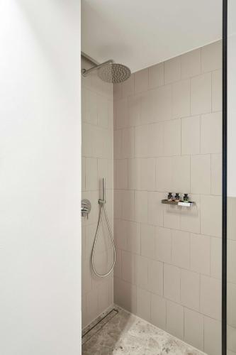 a bathroom with a shower with a shower head at The Social Athens Hotel, a member of Radisson Individuals in Athens