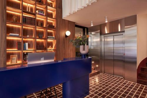 an office with a blue desk and a laptop at The Social Athens Hotel, a member of Radisson Individuals in Athens