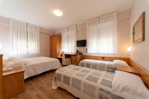 Postel nebo postele na pokoji v ubytování Hotel Lilla'