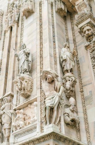 a building with statues on the side of it at Luxury House Lupetta 3 in Milan