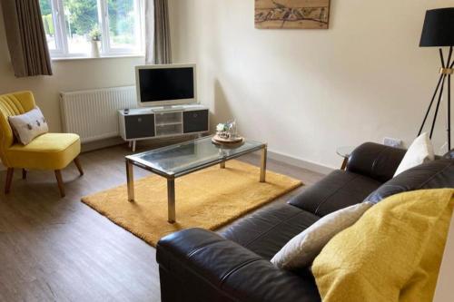 a living room with a couch and a coffee table at Delightful 2 bedroom house between Bristol & Bath in Warmley