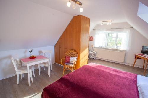 Un dormitorio con una cama y una mesa y un comedor. en Apfelhof Wegener Elstar Topaz, en Jork