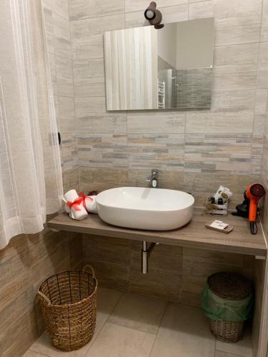 a bathroom with a white sink and a mirror at Villa Anna GuestHouse in Brindisi