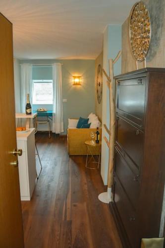 a living room with a refrigerator in the middle of a room at moderne Ferienwohnung in Merano
