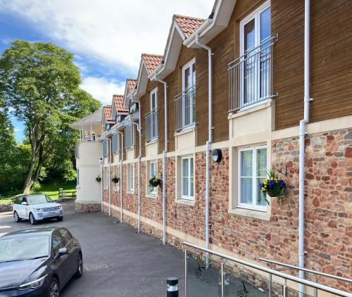 a car parked in front of a brick building at Wookey Hole Hotel in Wells