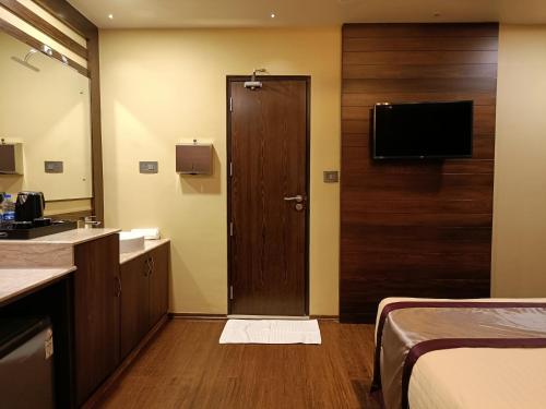 a hotel room with a bathroom with a door and a sink at Retrieve Health & Wellness in Cochin
