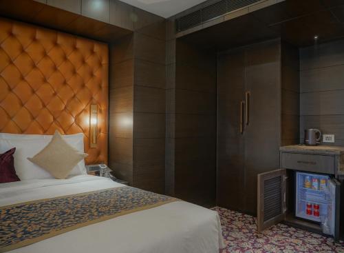 a hotel room with a bed and a fireplace at The Kabo in Srinagar
