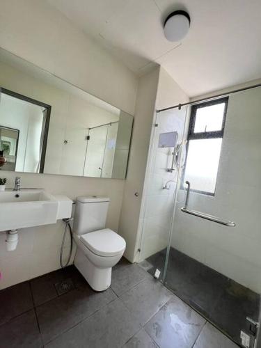 a bathroom with a toilet and a sink and a shower at Lily Ville in Tanah Rata