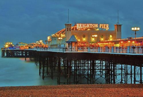 a pier with a britonian pier at night at Fidelity Stays Ocean Themed Luxury Apartment in Brighton & Hove