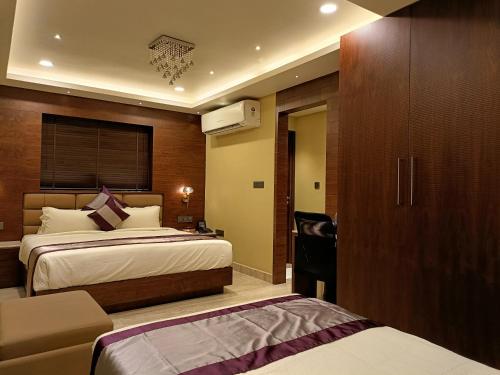 a hotel room with two beds and a closet at Retrieve Health & Wellness in Cochin