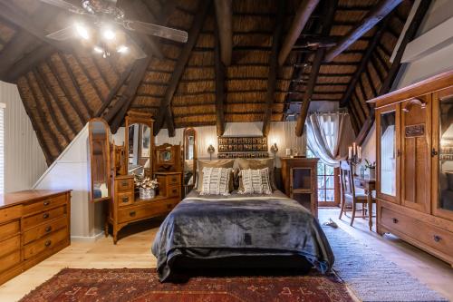 a bedroom with a bed and a wooden ceiling at 30 Mimosa in Mtunzini