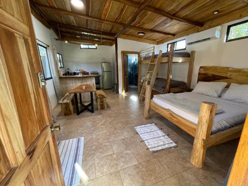 a bedroom with a bunk bed and a kitchen at A Nature Lovers Paradise! - Iona Villas in Sámara