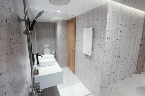 a bathroom with a sink and a mirror at HOTEL 12 in Gjakove