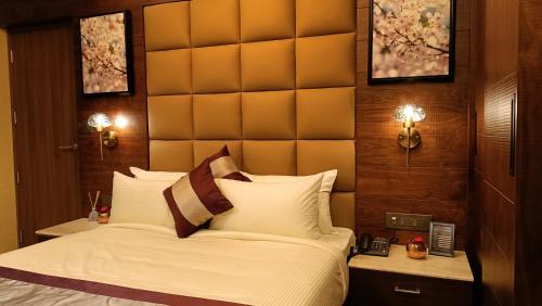 a bedroom with a large bed with a large headboard at Retrieve Health & Wellness in Cochin